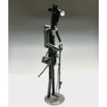 A scrap steel sculpture of an American Soldier, late 20th century, standing with his rifle, the base