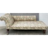 A Victorian oak chaise longue with a padded back, arm and seat, on turned tapering legs. Height