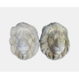 A pair of composition stone lion wall masks. Height 39cm, width 29cm.