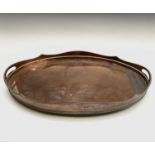 A late Victorian oval large copper gallery tray, with gadrooned rim and bun feet, width 61cm.