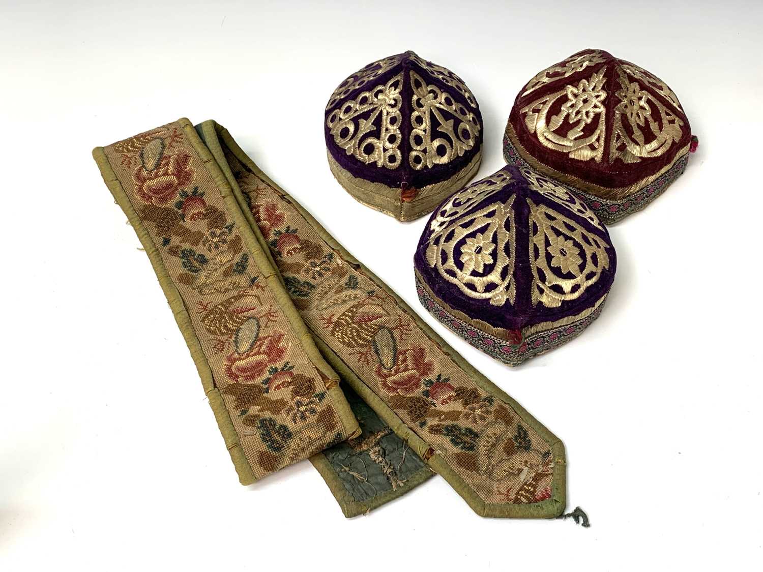 Three eastern skull caps, circa 1920, each embroidered and with gold thread decoration, together a - Image 11 of 13
