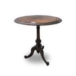A Victorian walnut tripod table. Height 60cm, diameter 53cm.