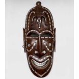 Solomon Islands, A hardwood and mother of pearl inlaid mask, second half 20th century, carved with a