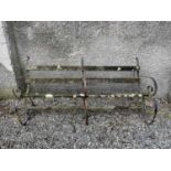 A garden bench with three wrought iron supports. Width 176cm.