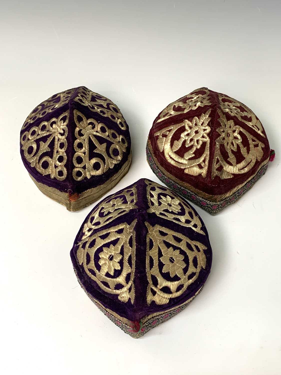 Three eastern skull caps, circa 1920, each embroidered and with gold thread decoration, together a - Image 7 of 13