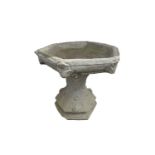 A reconstituted stone bird bath, with hexagonal top and acanthus leaf decoration. Height 40cm, width