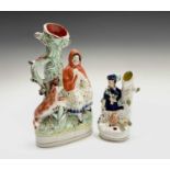 A Victorian Staffordshire quill holder/spill vase, modelled as a seated figure beside a dog and a