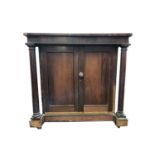 An early 19th century rosewood side cabinet, the pair of panelled doors flanked by columns, height