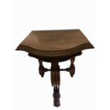 A Victorian mahogany narrow side table, the bow front top with moulded frieze, upon a heavily carved