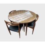 A Danish teak dining table and a set of four dining chairs, table diameter 110cm, chairs height