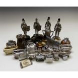 A large collection of table lighters, including four modelled as knights with musical movements to