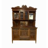 A late Victorian walnut sideboard, the raised back with twin glazed doors flanked by mirrored and