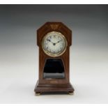 A German mahogany and inlaid torsion mantel clock, circa 1910, with circular enamel dial, the
