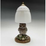 A late 19th century continental porcelain lamp base, modelled as an owl, with inset glass eyes,