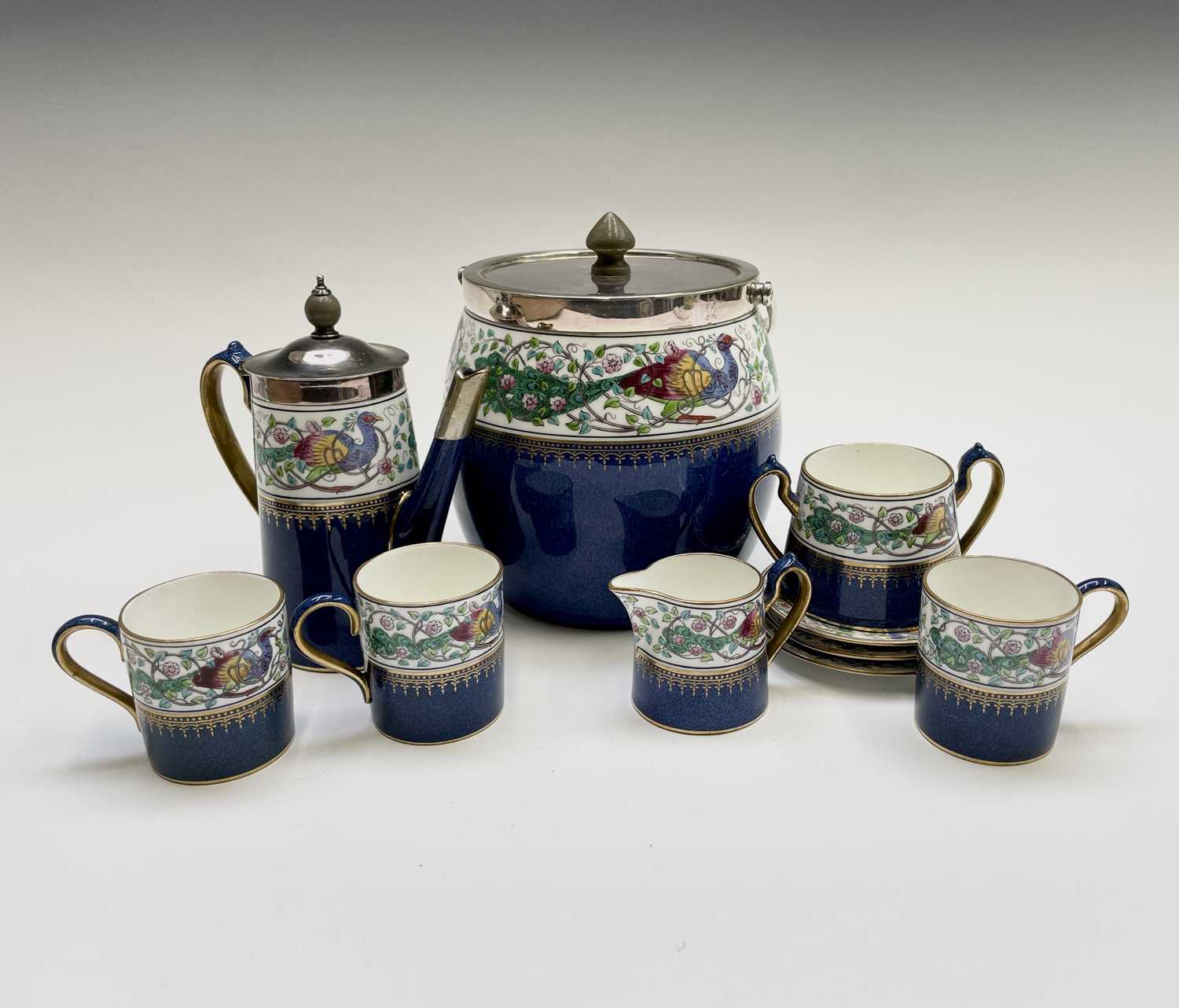 A Wedgwood part coffee set, decorated in blue and gilt with a floral entwined peacock border,