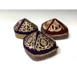 Three eastern skull caps, circa 1920, each embroidered and with gold thread decoration, together a