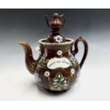 A Victorian Measham treacle glazed bargeware large teapot, with teapot finial, applied with