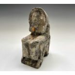 A 20th century carved stone figure of a seated Pharoah. Height 30cm.