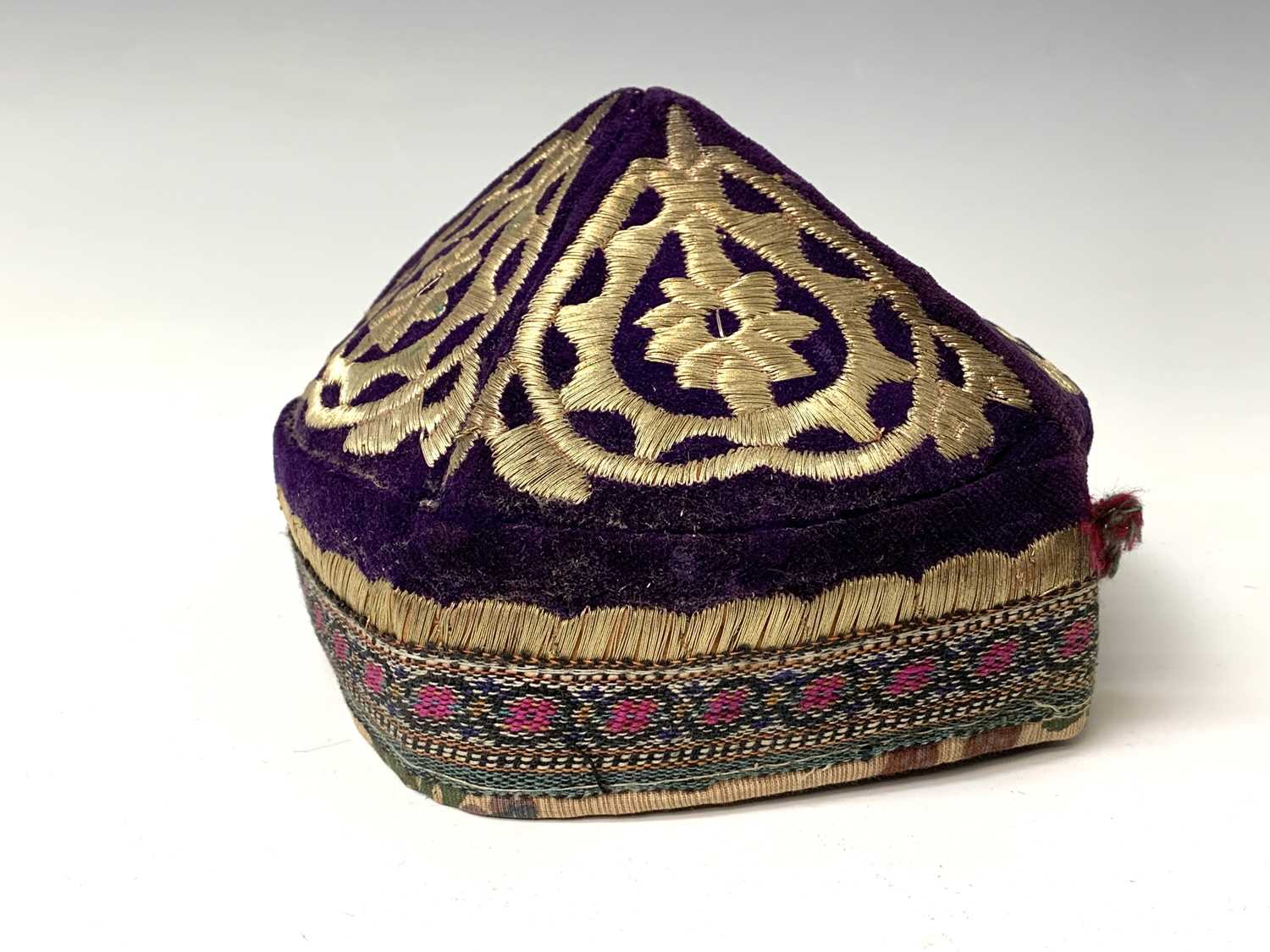 Three eastern skull caps, circa 1920, each embroidered and with gold thread decoration, together a - Image 2 of 13