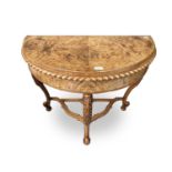 A Regency style walnut demi lune card table, with acanthus leaf carved cabriole legs. Height 76cm,