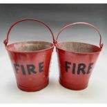A pair of red painted 'FIRE' buckets. Height 31cm (excluding handle).