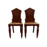 A pair of oak hall chairs with Prideaux coat of arms, circa 1888, with octagonal tapering and turned