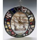 A Victorian lead lined stained glass oval panel, depicting a galleon to the centre, 39 x 35cm.