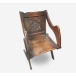 A Glastonbury oak armchair, late 19th century, of typical form, the back carved with initials 'I.h.