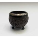 A 19th century coconut cup, with silver plated liner and bun feet, height 8.5cm, diameter 9.5cm.