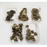 Five sets of antique brass furniture handles, iincluding a set of twelve drawer knobs with plates.