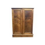 A Victorian elm collectors cabinet, with a pair of doors opening to reveal five drawers, on a plinth