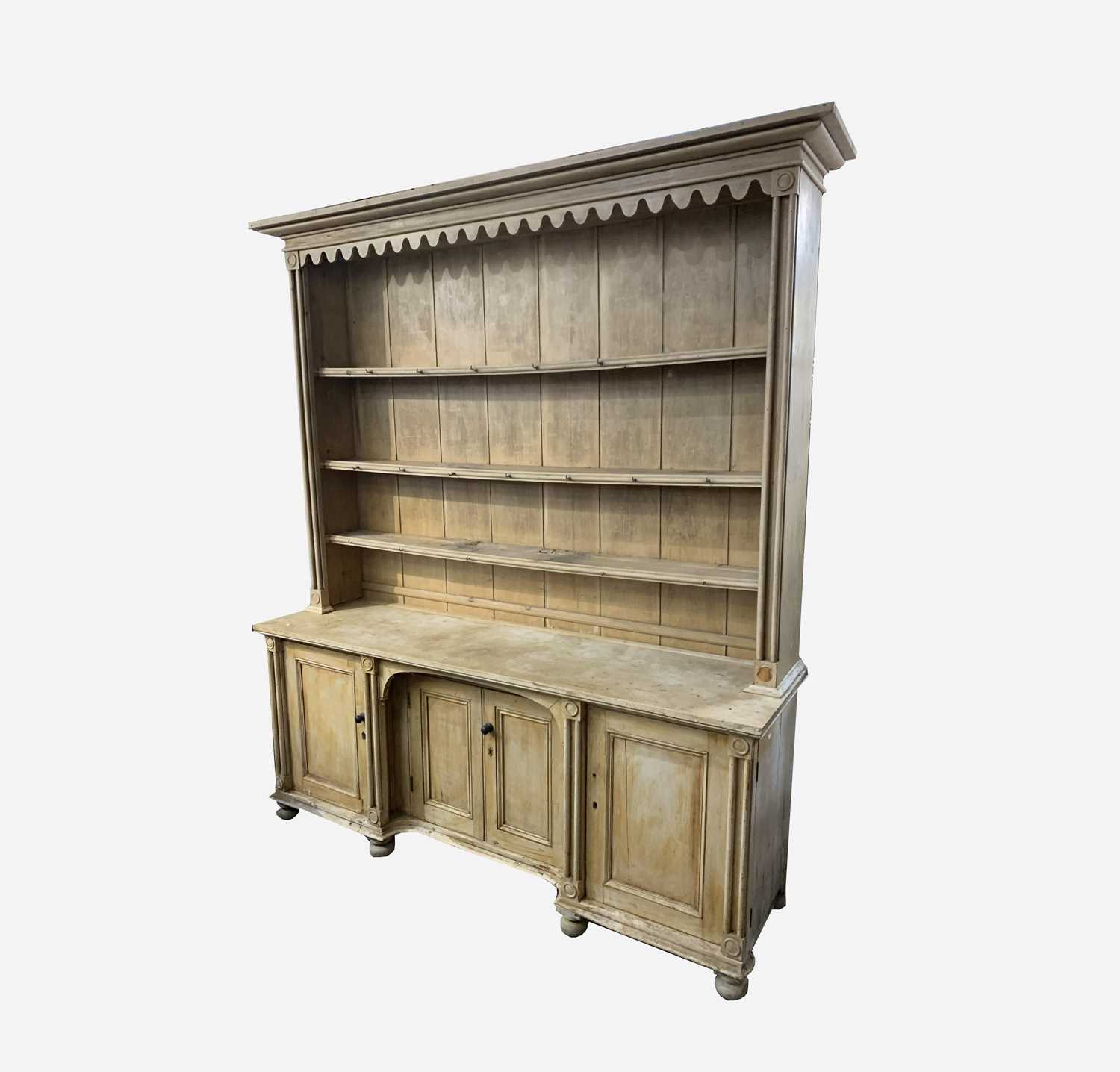 A Cornish pine kitchen dresser, 19th century, of large proportions, with moulded and arcaded frieze,