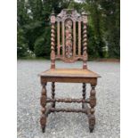 A Victorian carved oak side chair, with a rattan seat, height 115cm, width 54cm.