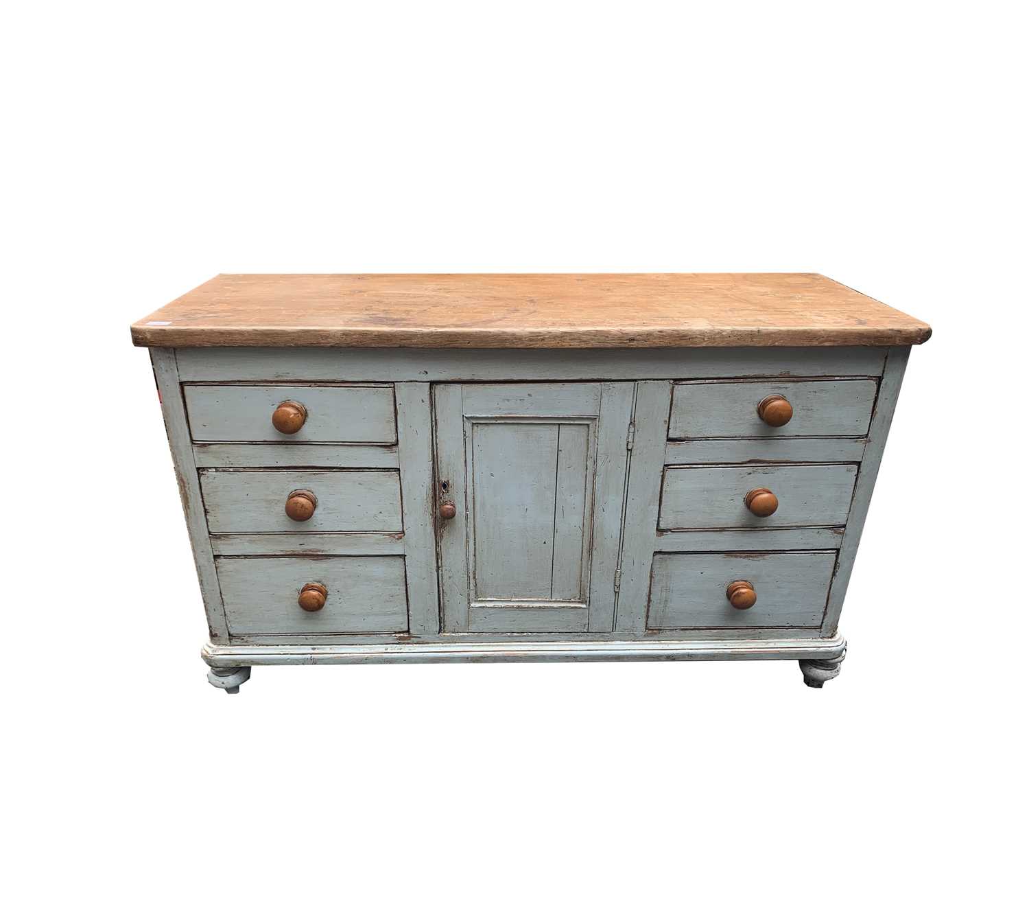 A Victorian painted pine low dresser, with a central panelled door flanked by six drawers, height