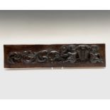 A carved oak rectangular panel, 19th century, with cherubs and scrolling acanthus leaves, 13 x