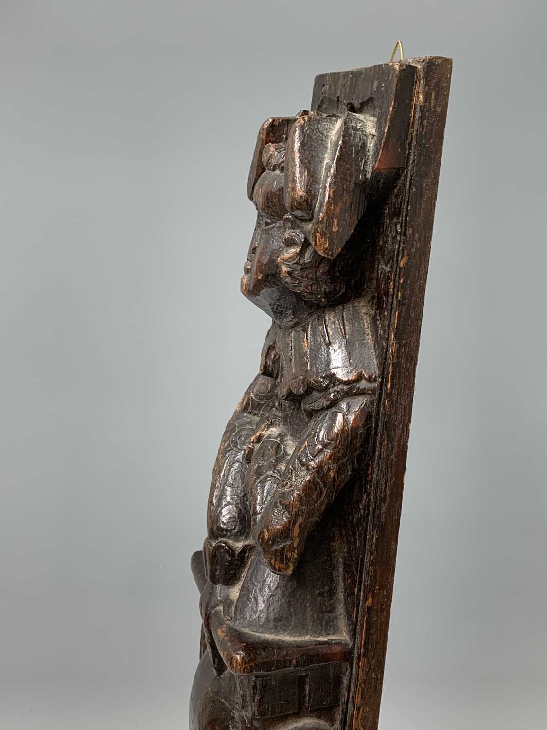 An oak carved oak term panel, 16th century, depicting a male figure rising above a vacant - Image 9 of 10