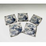 A set of five Dutch Delft blue and white tiles, 18th century, each painted with sailing boats and