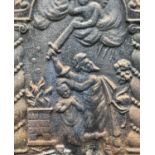 A cast iron fire back, probably circa 1900, depicting Abraham and Issac, now fitted a grate,