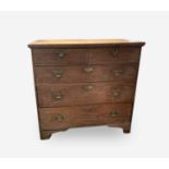 A George III oak chest of drawers, with two short and three long drawers, on bracket feet, height