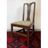 An 18th century single walnut side chair, the vase shaped solid splat, above a drop in seat height