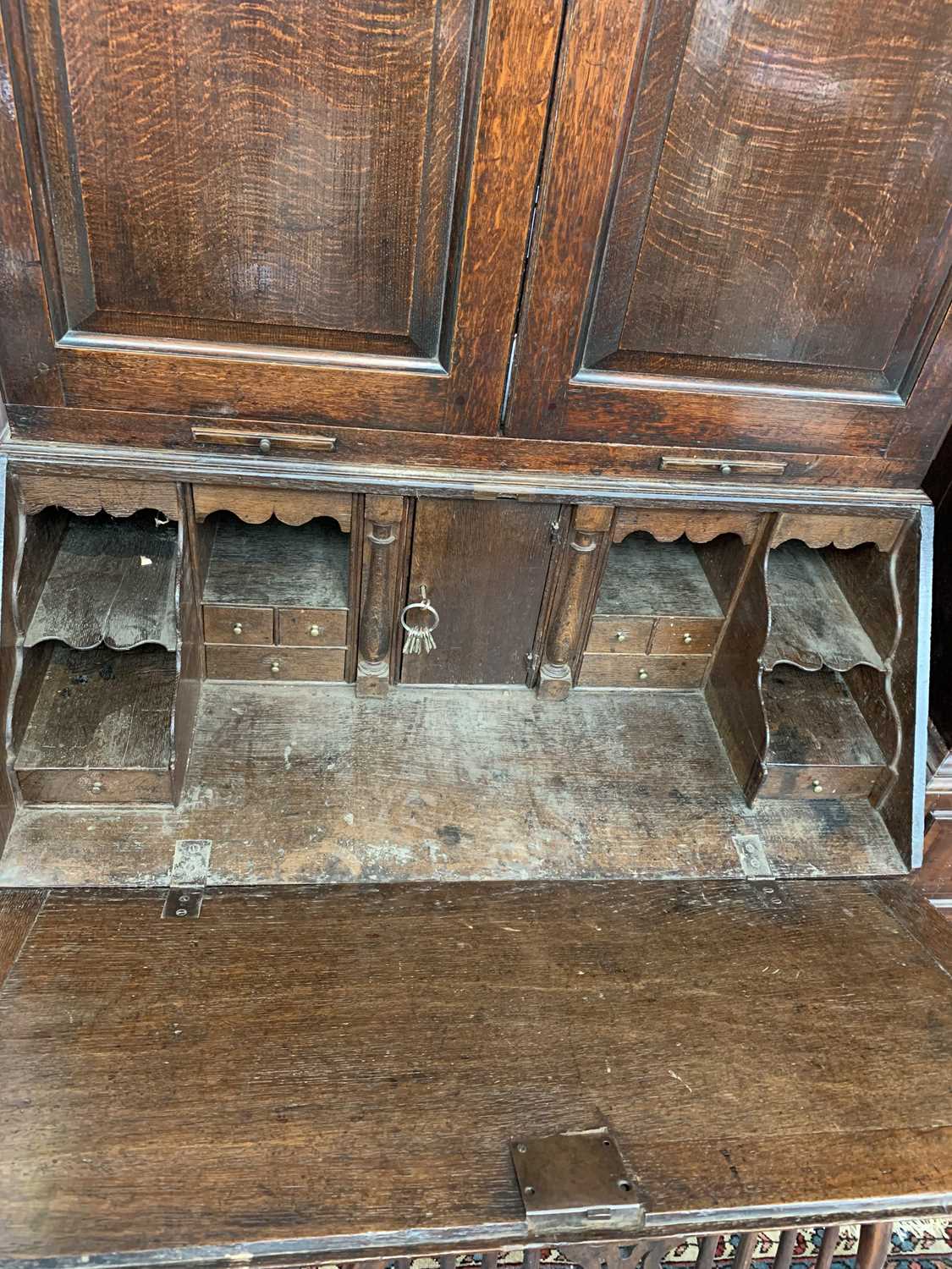 A George III oak bureau bookcase, with a pair of arched panelled doors opening to reveal shelves and - Image 6 of 6