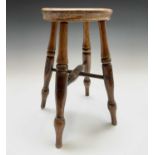 An elm and beech stool, 19th century,.the circular top on turned legs joined by an X stretcher,