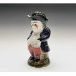 A Staffordshire pottery Toby jug, early 19th century, standing with his hands in his waistcoat