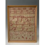 A 19th century woolwork alphabet sampler, by Lillie Jane Tolglase, aged 13 years, St. Breage School,