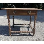 An 18th century oak side table, with a single frieze drawer on barley twist legs and stretchers,