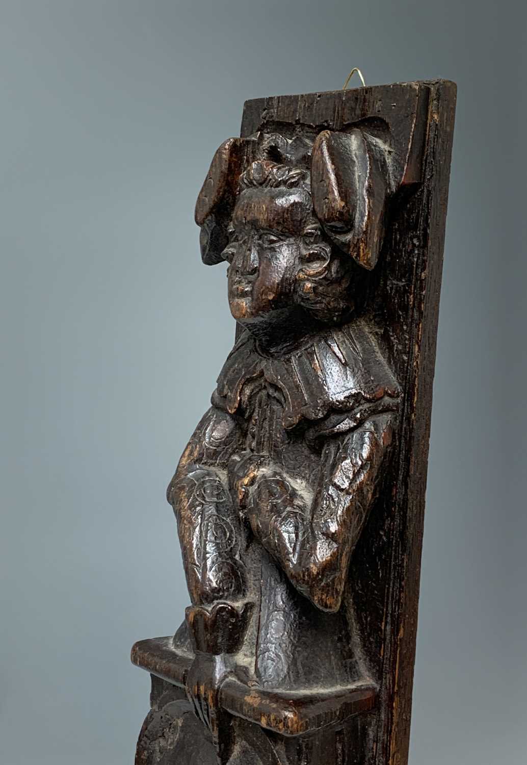 An oak carved oak term panel, 16th century, depicting a male figure rising above a vacant - Image 4 of 10