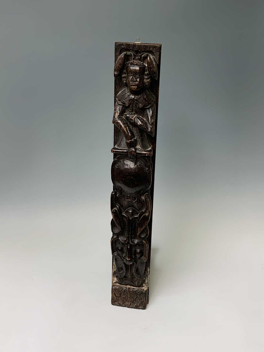 An oak carved oak term panel, 16th century, depicting a male figure rising above a vacant