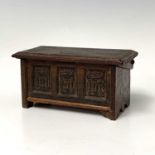 A miniature carved oak coffer, early 20th century, height 6.5cm, width 12.5cm, depth 6.7cm.