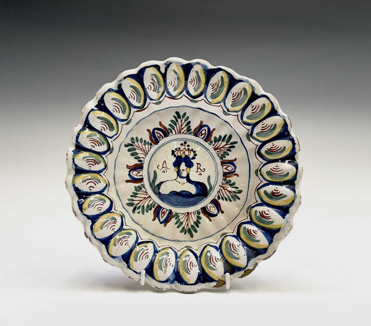 An English delft polychrome decorated lobed dish, probably Bristol, circa 1710, with royal