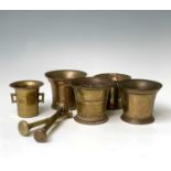 A small 17th century bronze mortar, height 9cm, diameter 9.5cm four brass and bronze mortars and two